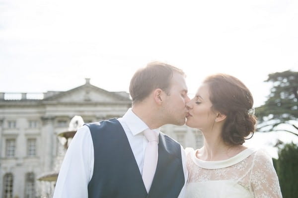 Bride and groom kiss outside Moor Park Mansion