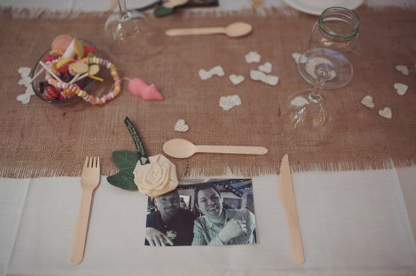Photograph and wooden cutlery on wedding place setting