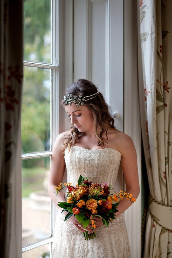 Bride holding autumnal wedding bouquet