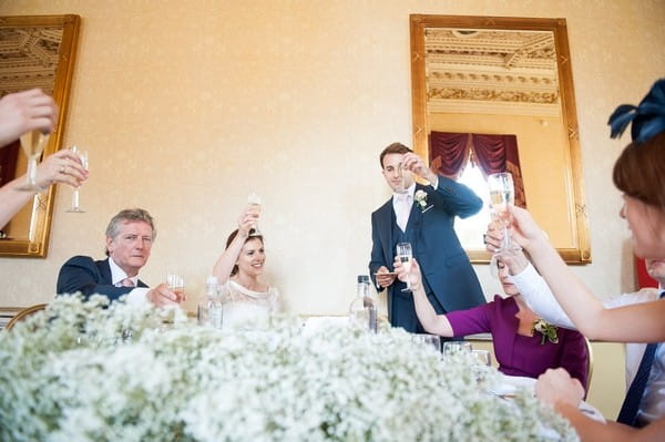 Groom raising toast during wedding speech