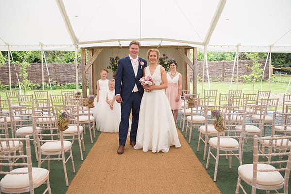 Bride and groom in marquee at Houchins