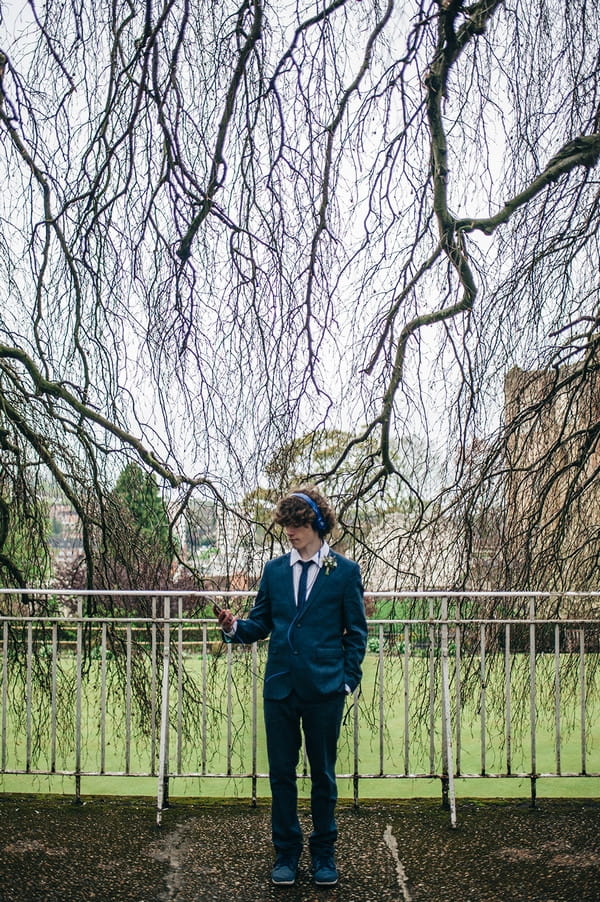 Young groomsman with headphones on