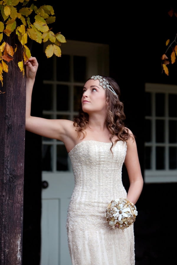 Bride looking up autumnal leaves