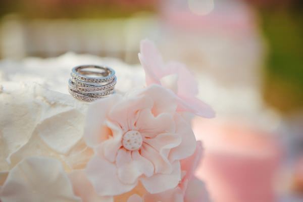 Wedding rings on top of wedding cake