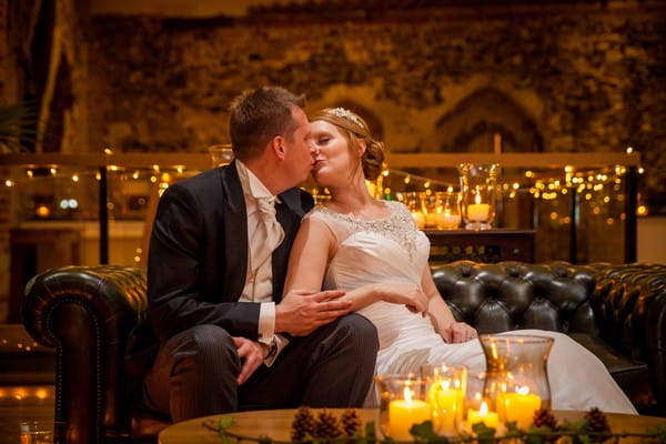 Bride and groom kissing on sofa - Picture by Amanda Karen Photography