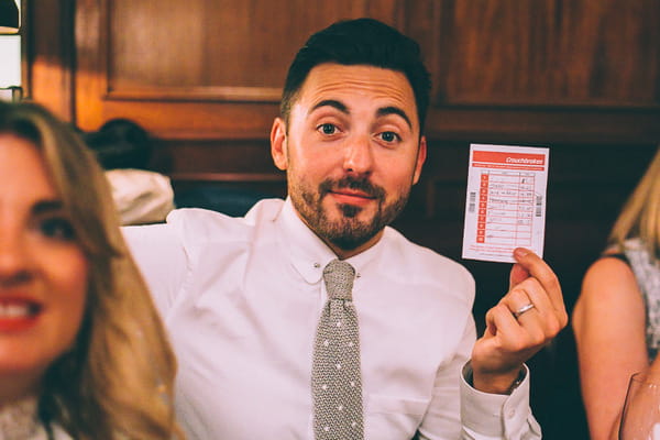 Wedding guest holding up betting coupon