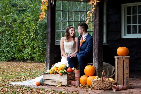 Bride and groom sitting in Deer Park secret garden in autumn