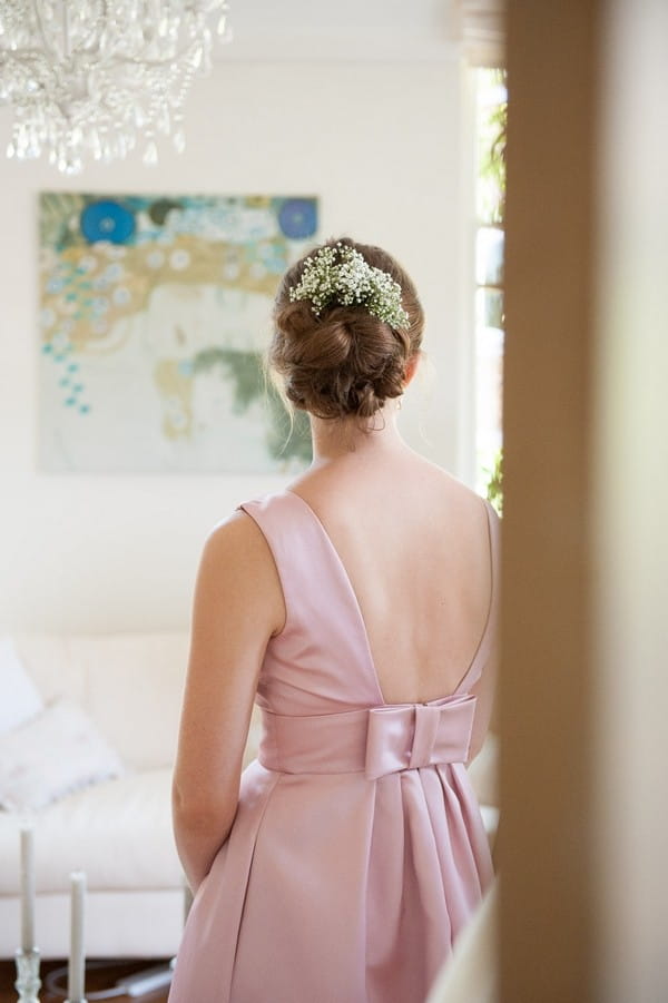 Bridesmaid with pink dress and hair accessory