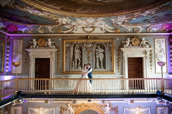 Bride and groom on balcony inside Moor Park Mansion