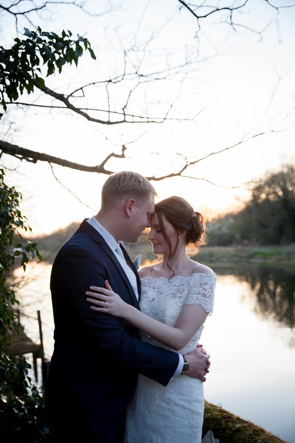 Bride and groom by lake - Picture by Amanda Karen Photography