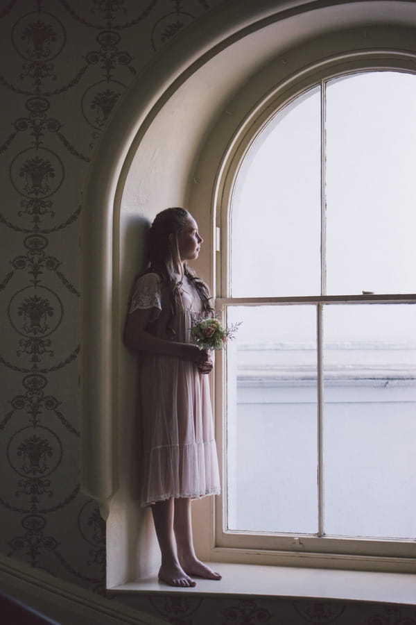 Flower girl standing in window