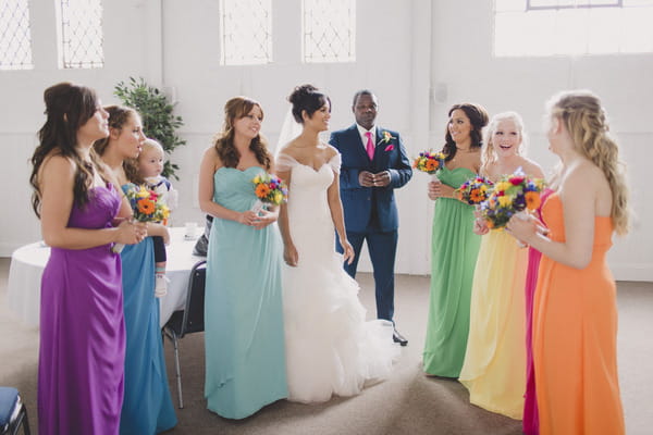 Bride with bridesmaids in brightly coloured dresses