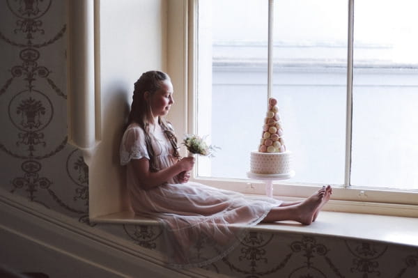 Flower girl sitting on window ledge