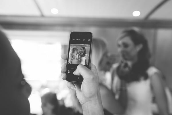 Taking picture of bride on phone