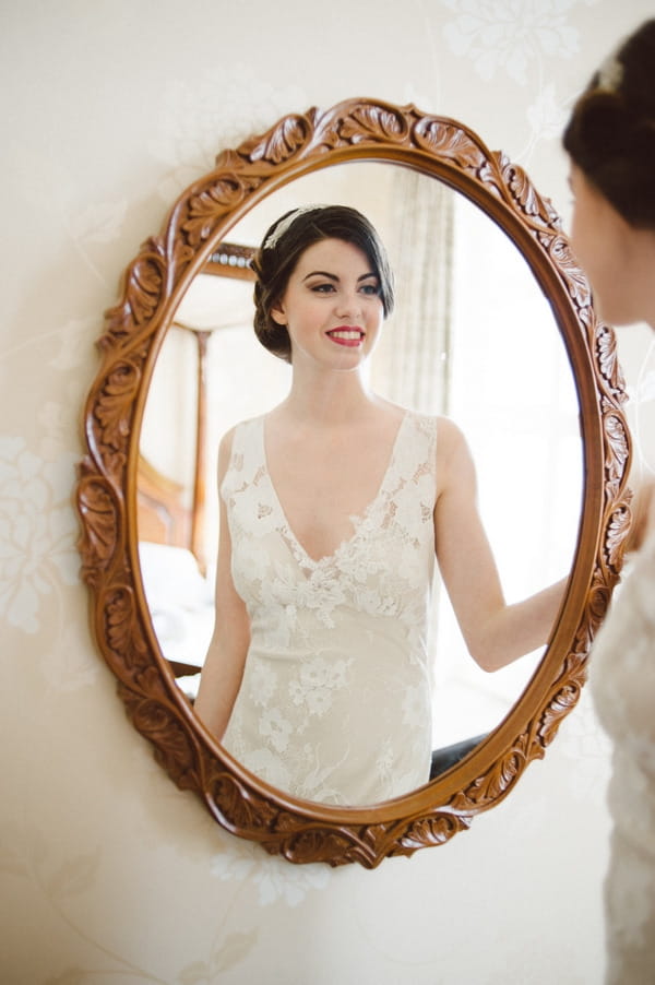 Retro bride looking in mirror