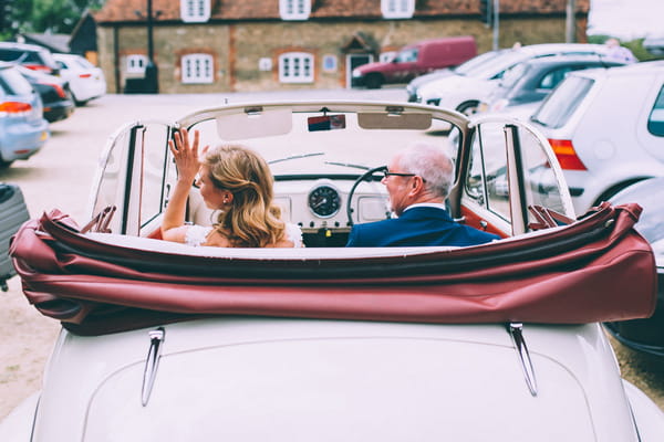 Father and bride in vintage Morris Minor wedding car