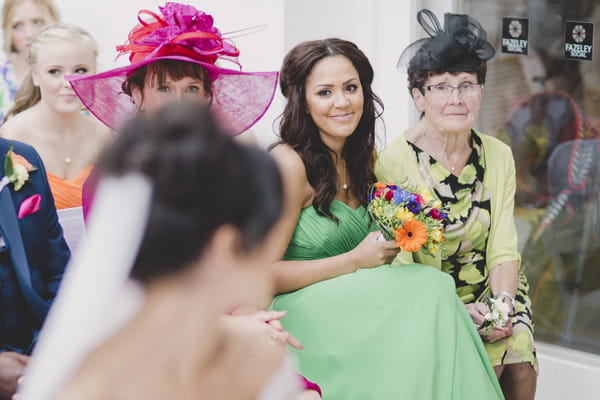 Bride looking over shoulder at friend