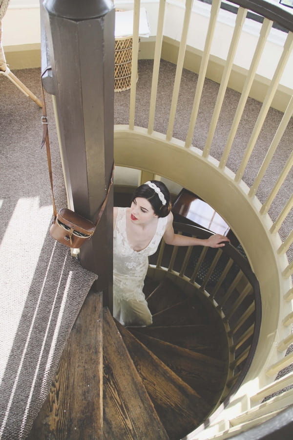 Bride walking up spiral staircase