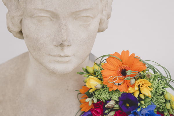 Brightly coloured wedding bouquet on statue