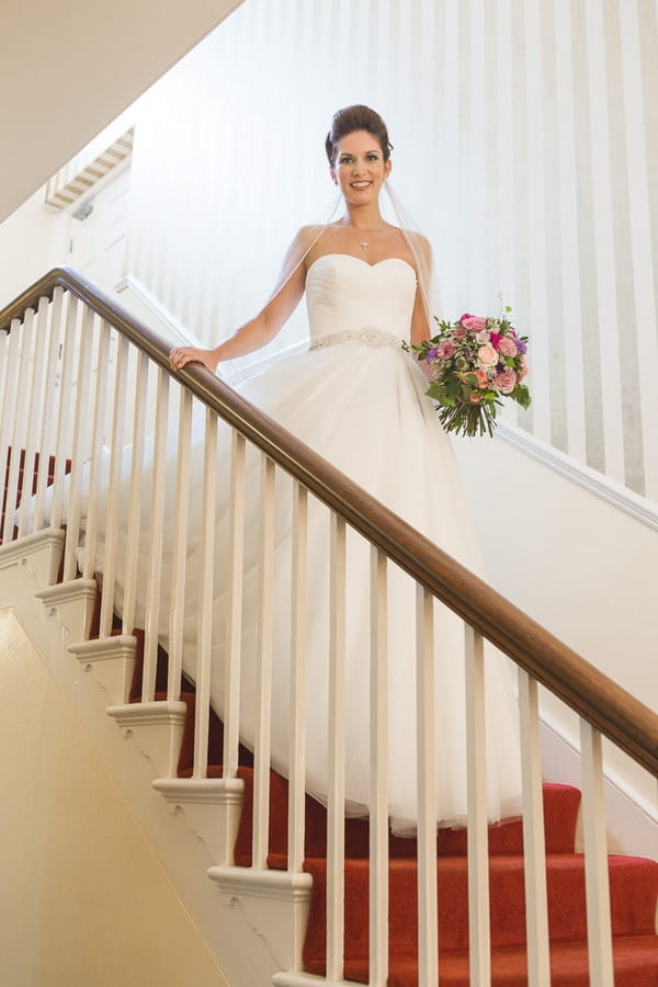 Bride walking down stairs of Horton Grange