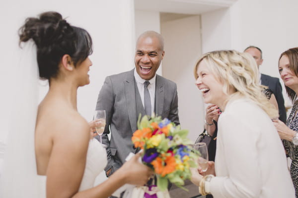 Bride laughing with wedding guests