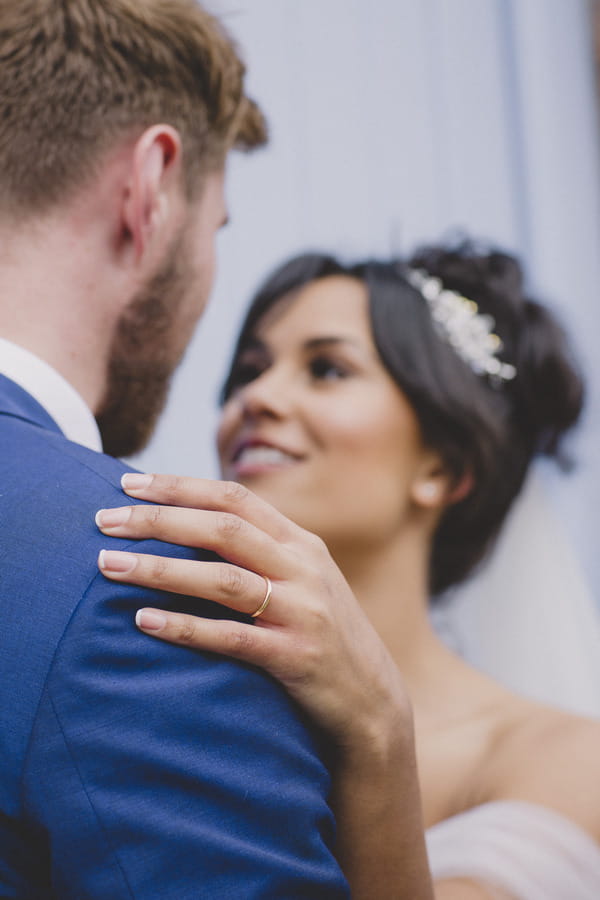 Bride's hand on groom's shoulder