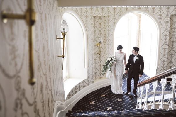 Bride and groom walking up stairs in Duke of Cornwall Hotel