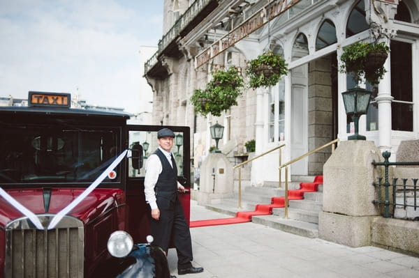 Retro taxi driver waiting outside Duke of Cornwall Hotel