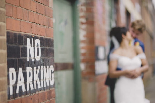 No parking notice with bride and groom in background