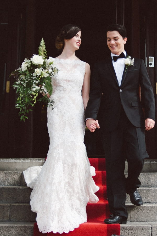 Bride and groom on steps of Duke of Cornwall Hotel