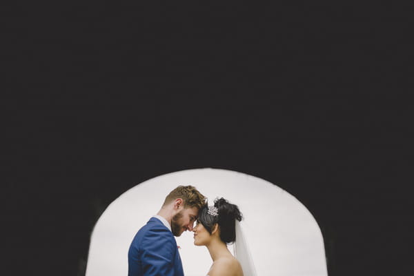 Bride and groom resting heads on each other