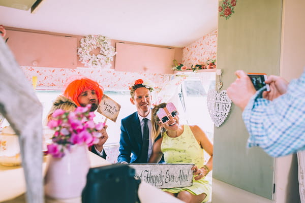 Wedding guests having picture taken with funny props