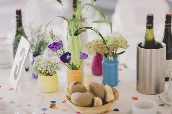 Small coloured vases of flowers