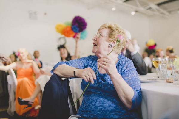 Wedding guest holding flower