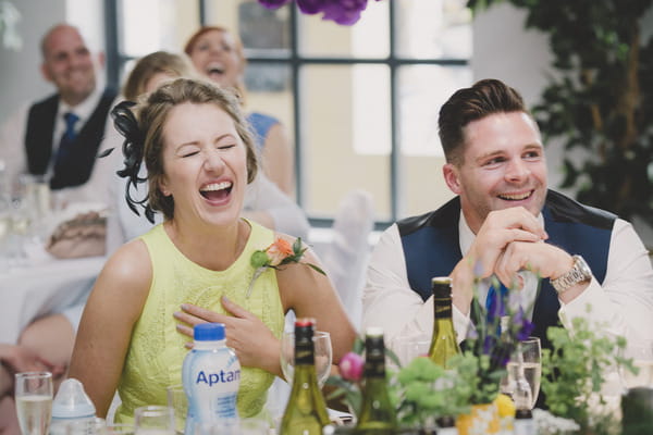 Guests laughing at wedding speech