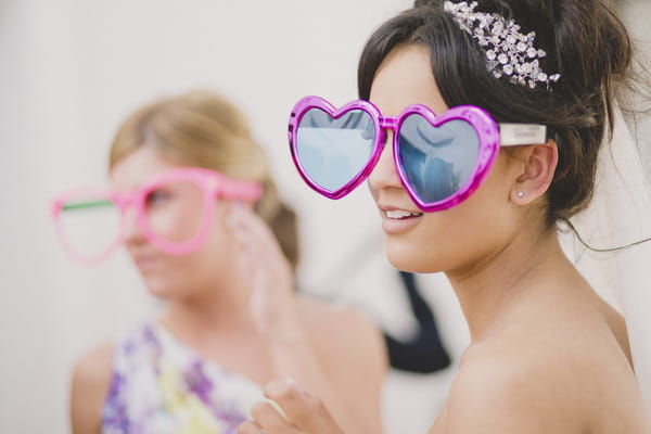 Bride with large heart sunglasses