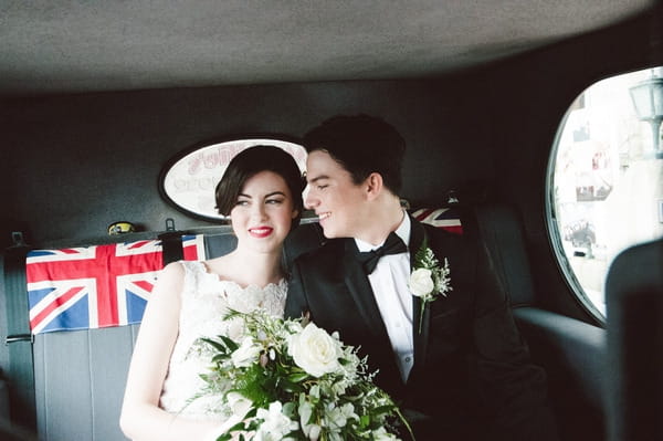 Retro bride and groom in back of cab