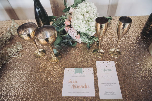 Wedding stationery and gold cups