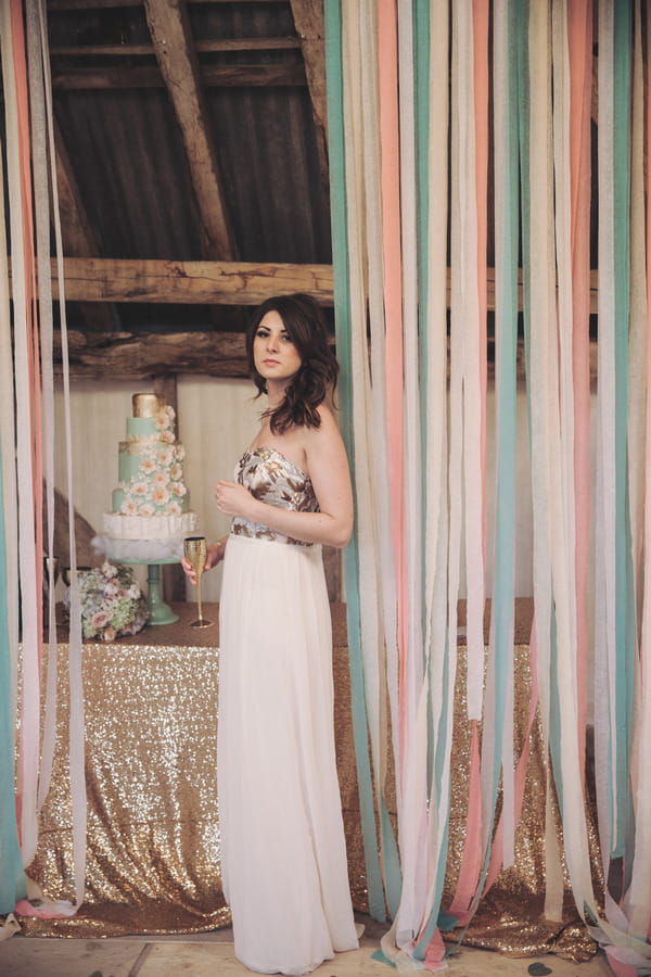 Bride standing with ribbons hanging down