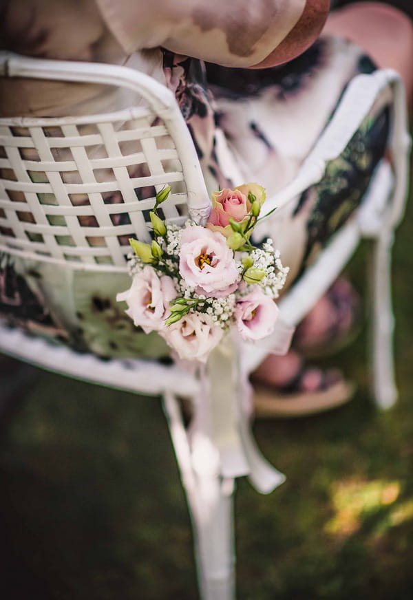 Flowers tied to wedding chair