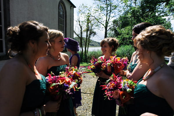 Bridesmaids holding bright bouquets