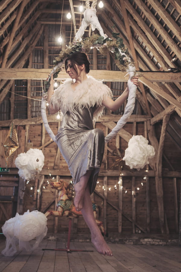 Bride sitting in trapeze ring