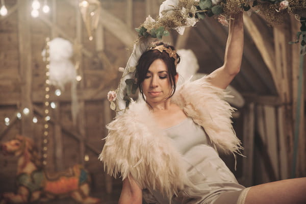 Bride sitting in trapeze ring