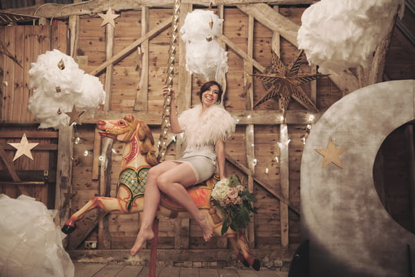 Bride sitting on carousel horse