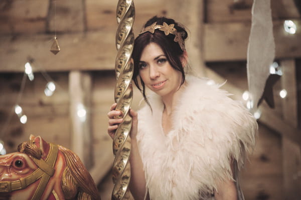 Bride holding onto carousel pole