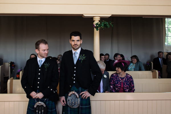 Groom in Scottish attire waiting at altar