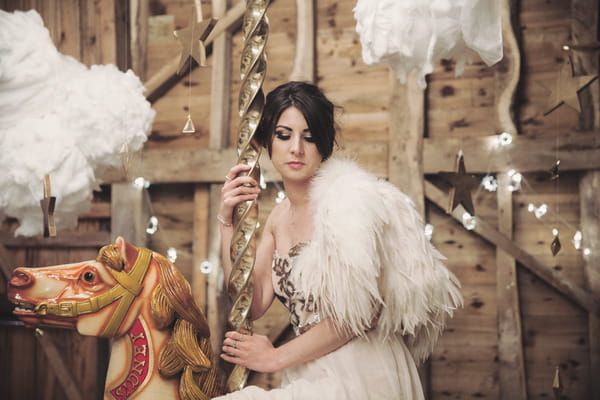 Bride sitting on carousel horse