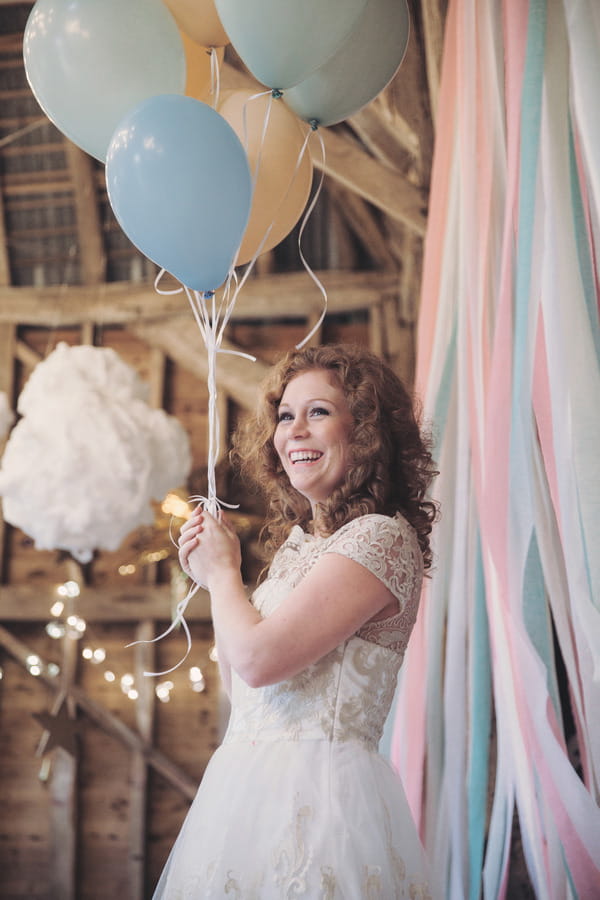 Bride smiling holding balloons