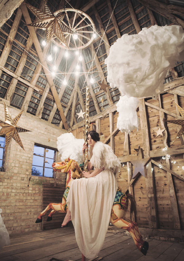 Bride sitting on carousel horse