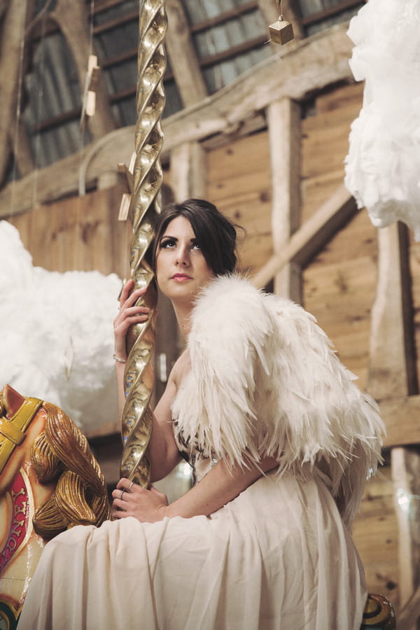 Bride sitting on carousel horse